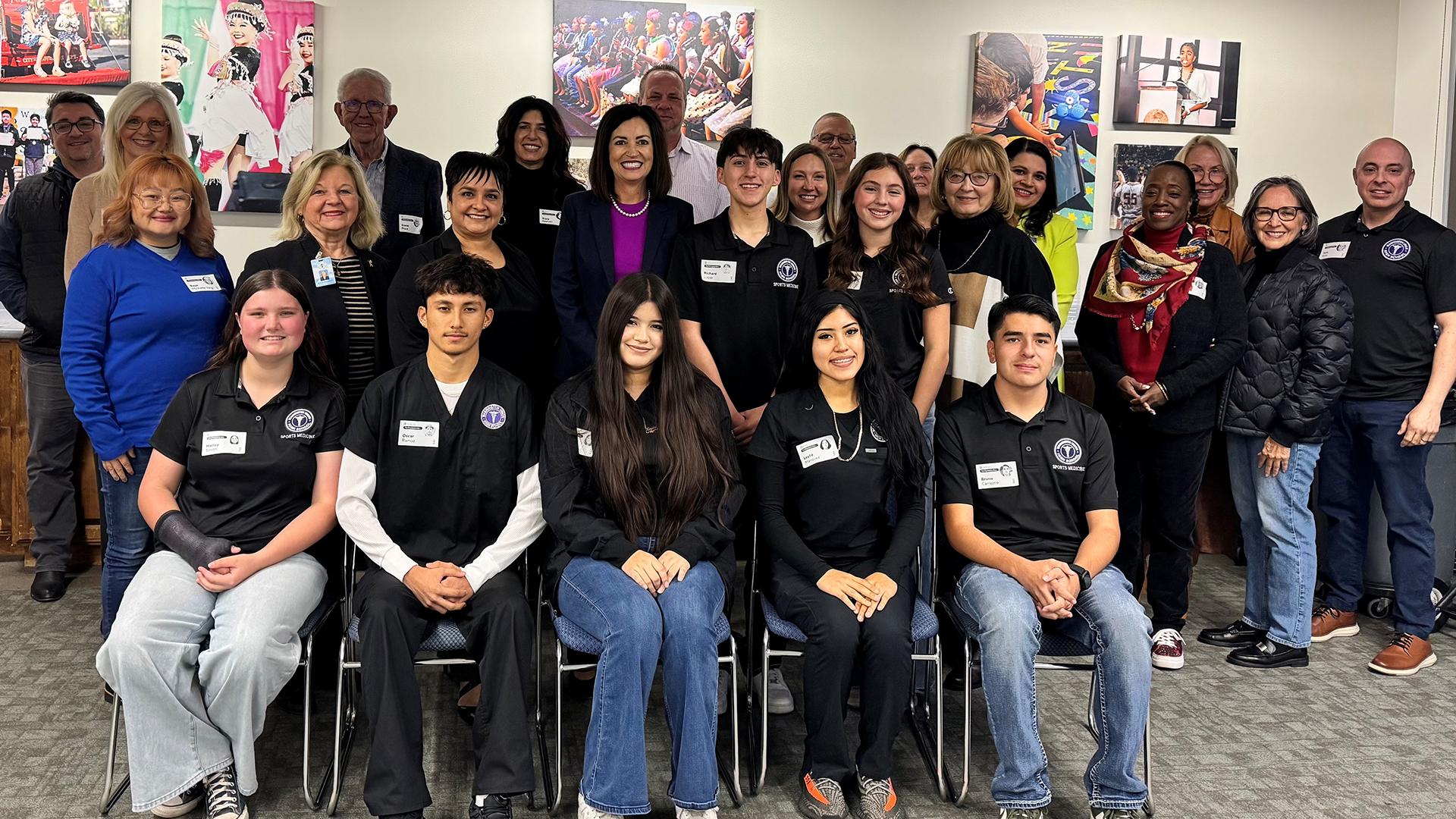 Students are posing with members of the board and FCSS staff.