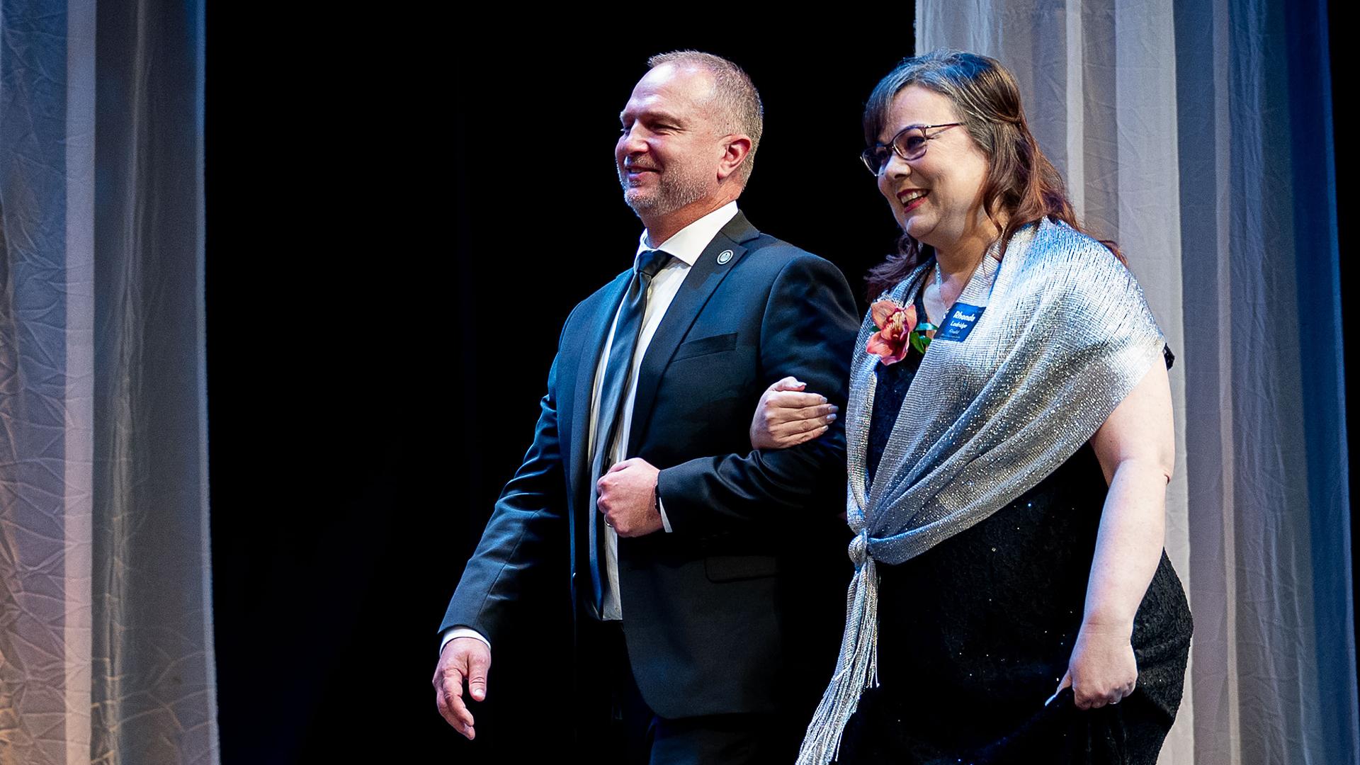 The Administrator of the Year finalist is being escorted onstage to be honored.