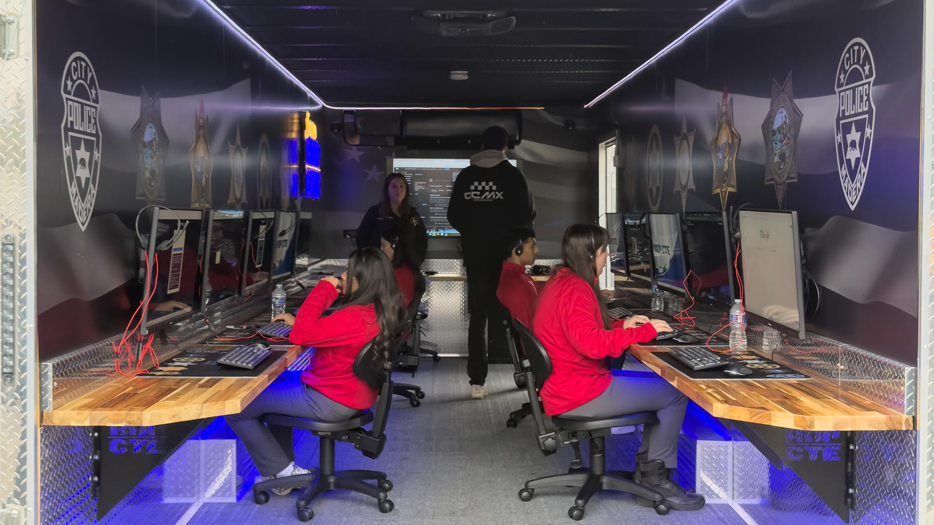 Students are in the Dispatch Trailer, working on simulations at desktops.