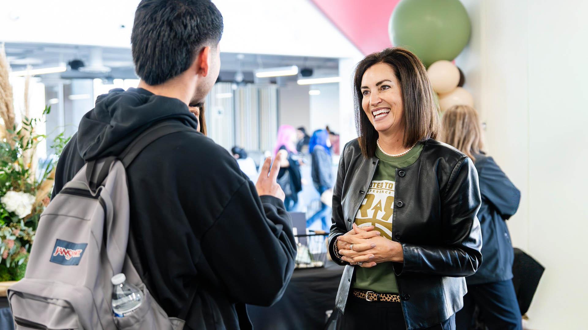 The Superintendent greets a student at the conference.
