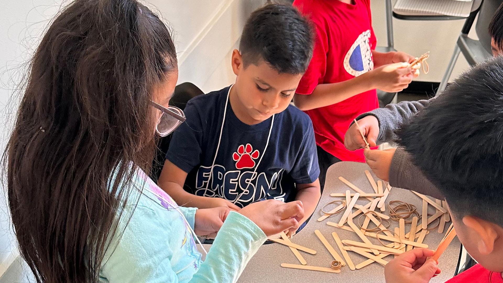 Students are creating with art supplies. 