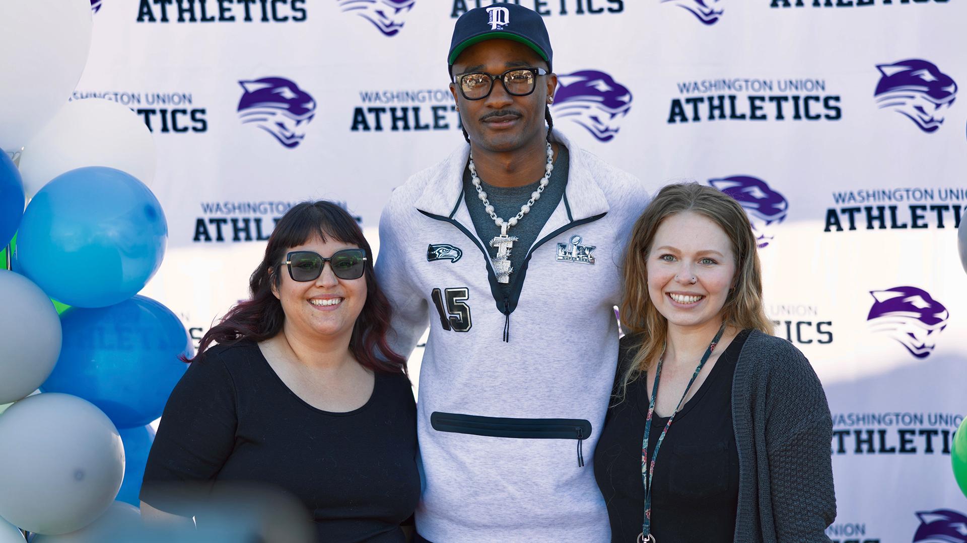 Three people are standing together. 