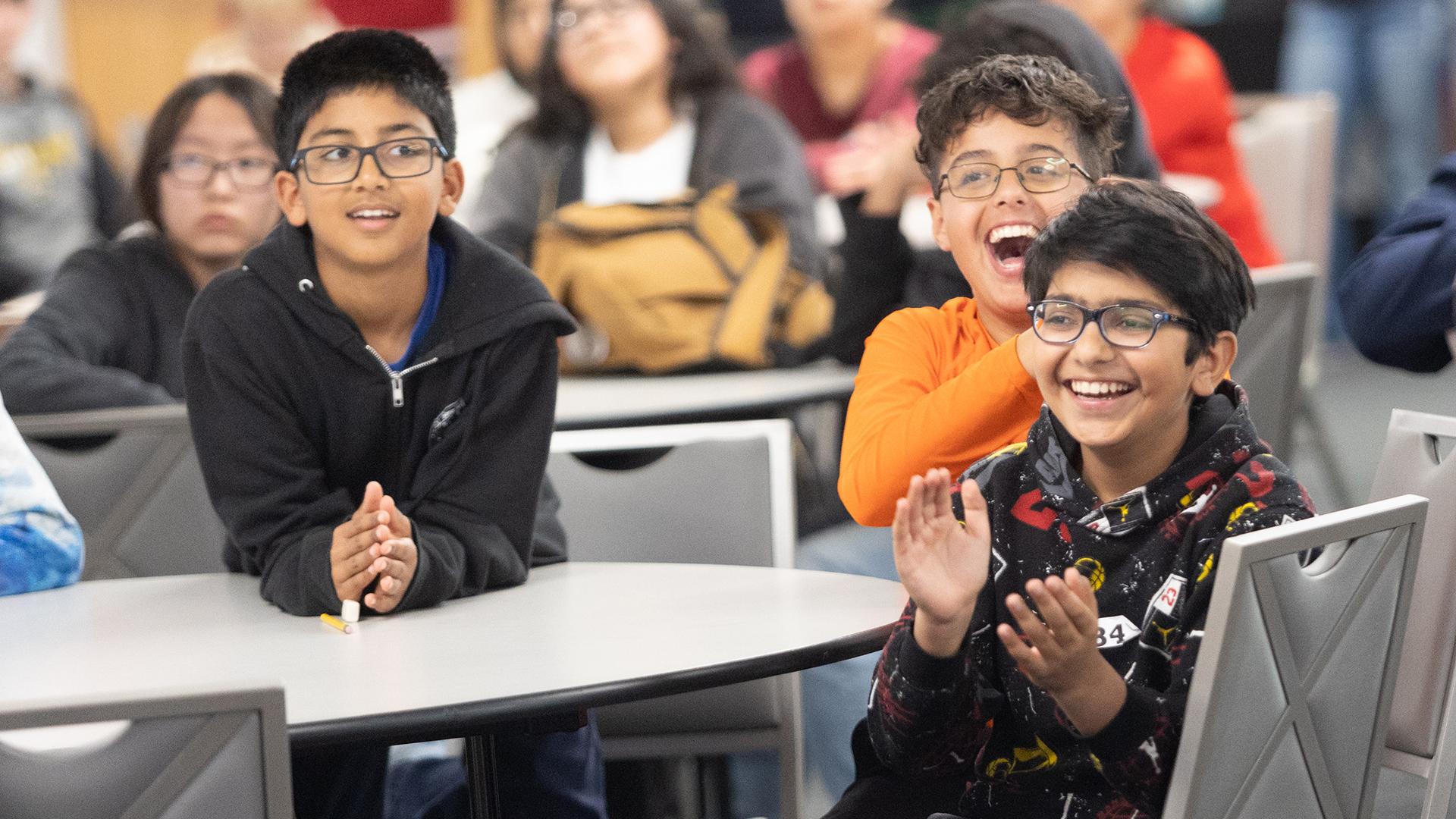 Students are sitting at desks. 