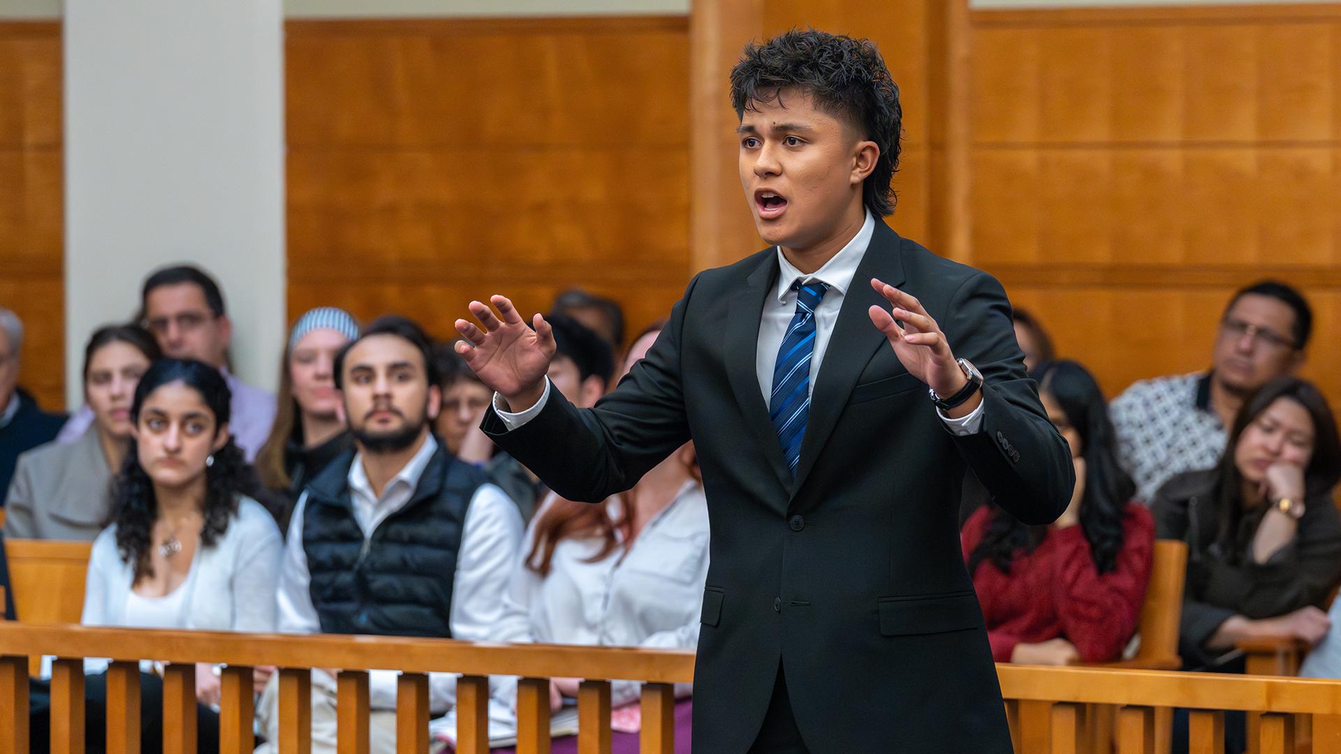 A student is presenting at Mock Trial. 