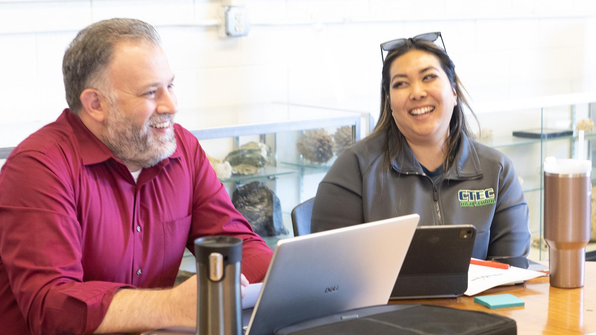 Two people are sitting at a table. 