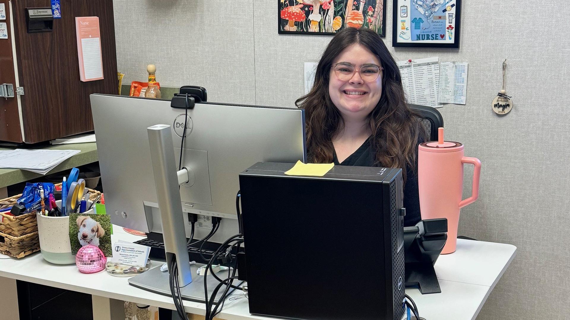 One person sits at a desk. 