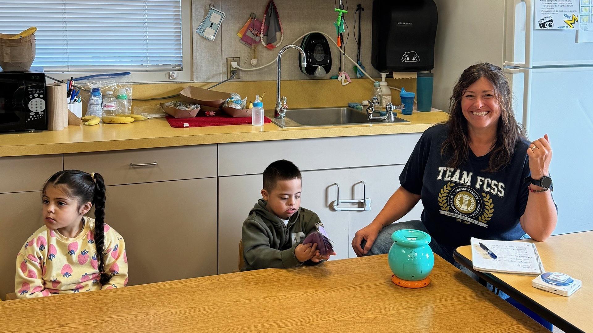 A staff member is with two students. 