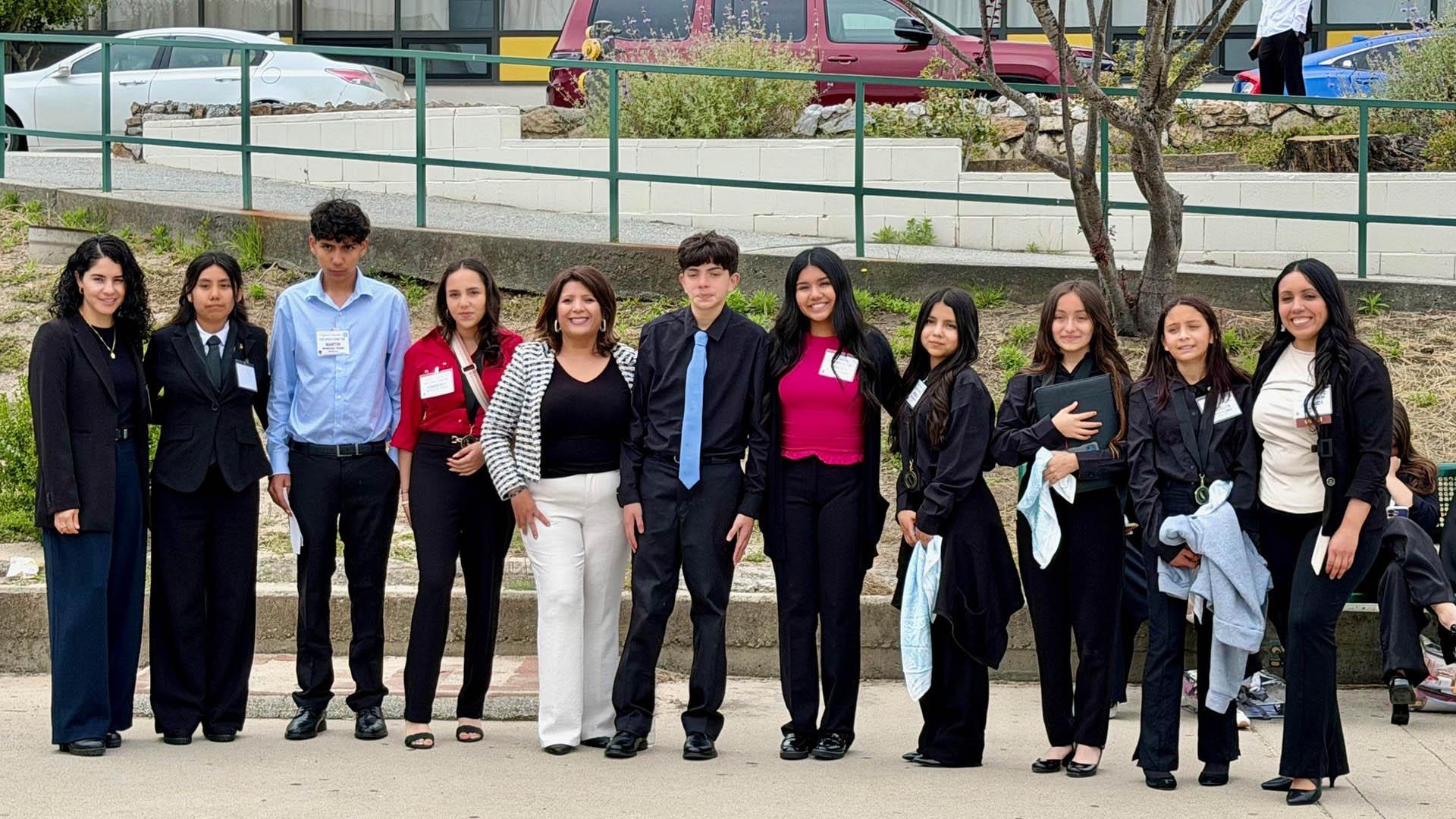 A group of students stand together. 