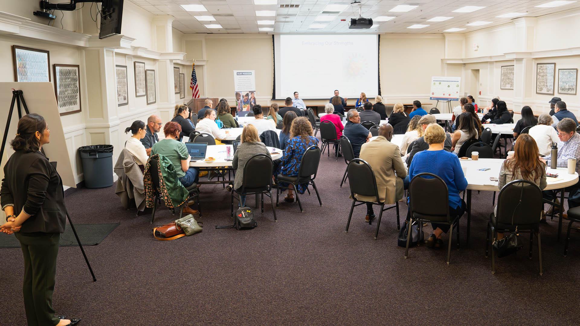 A group of people are in a meeting. 