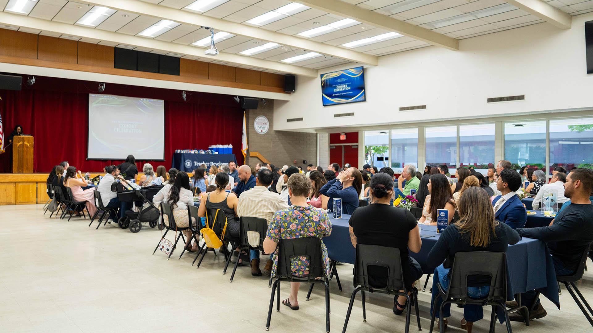 A group of people attend a meeting. 