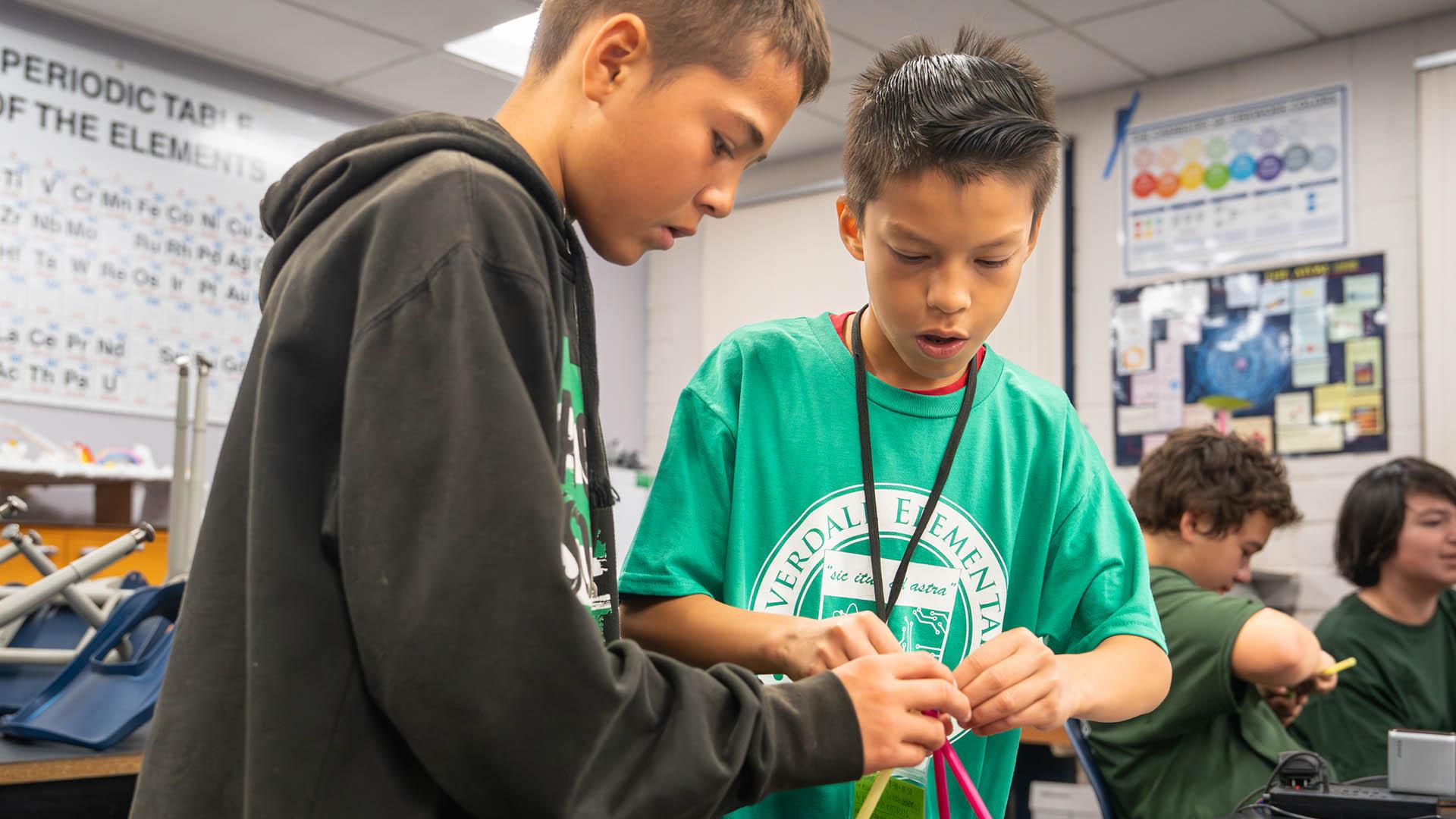 Two boys perform an experiment. 