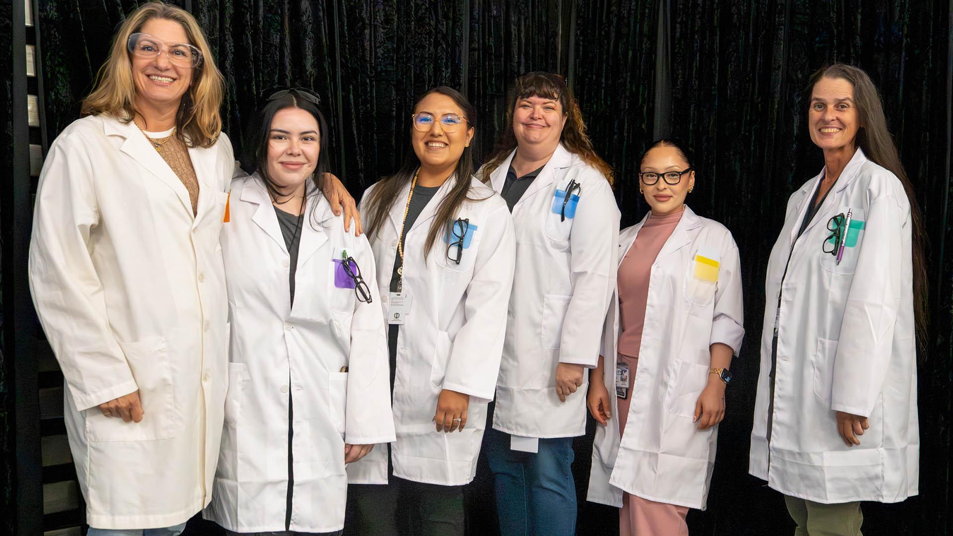 Staff are dressed in lab coats to fit the event theme. 