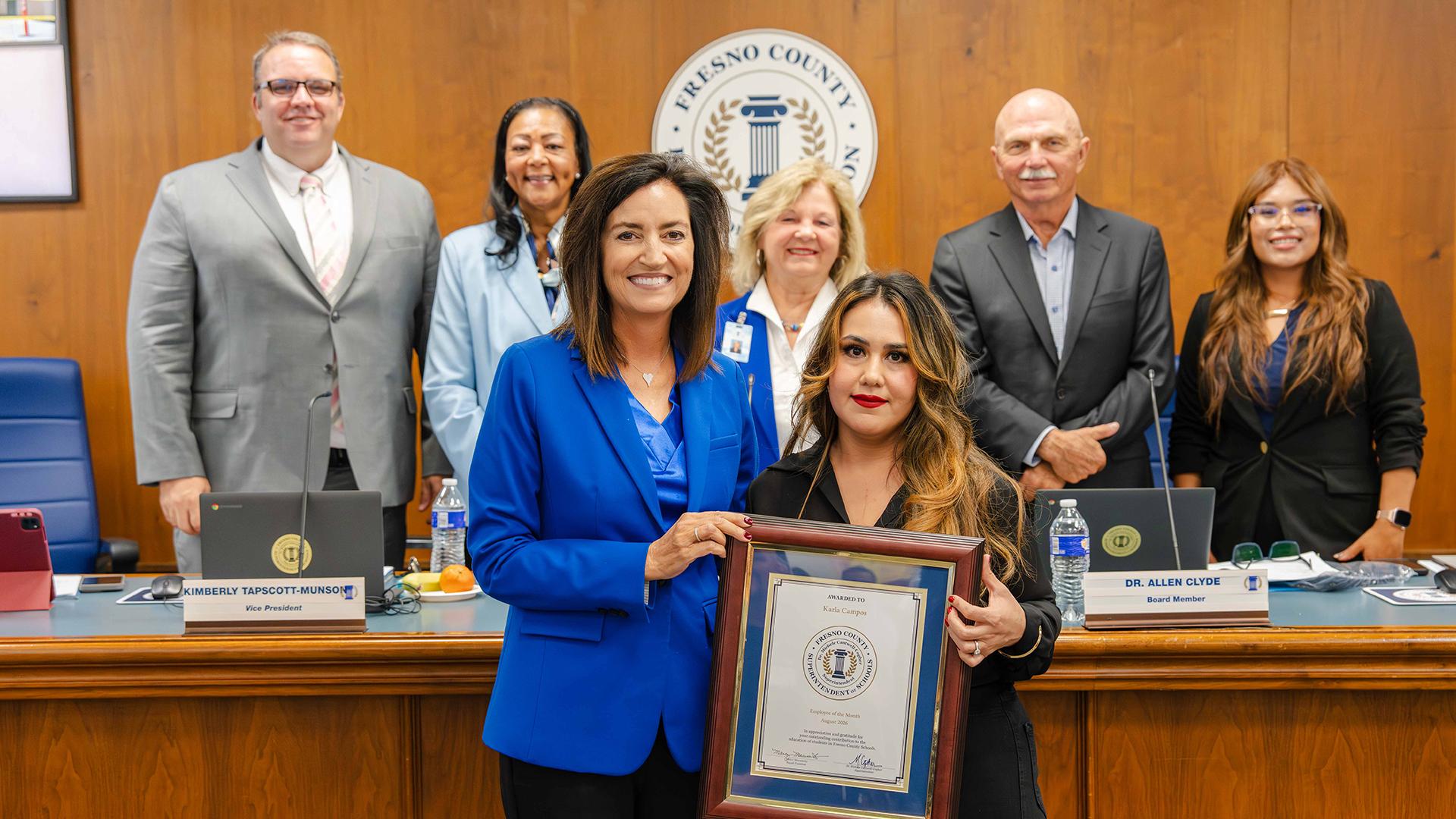 The August Employee of the Month is honored at the monthly board meeting.