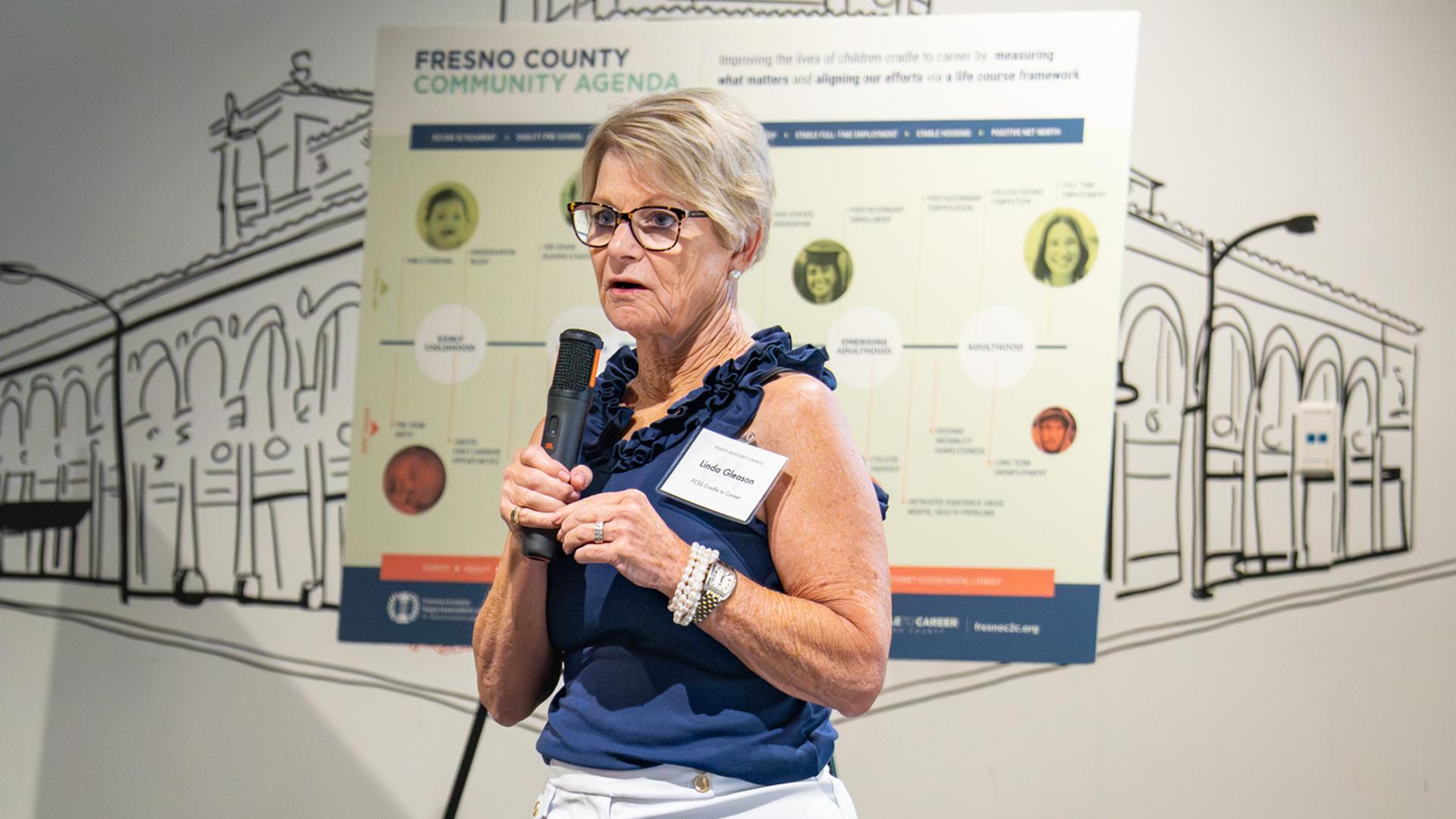 Linda Gleason speaks to a group about child and family success.