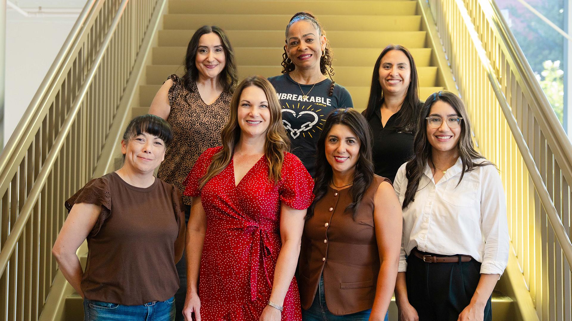 Seven FCSS team members all pose for a picture on the stairs.