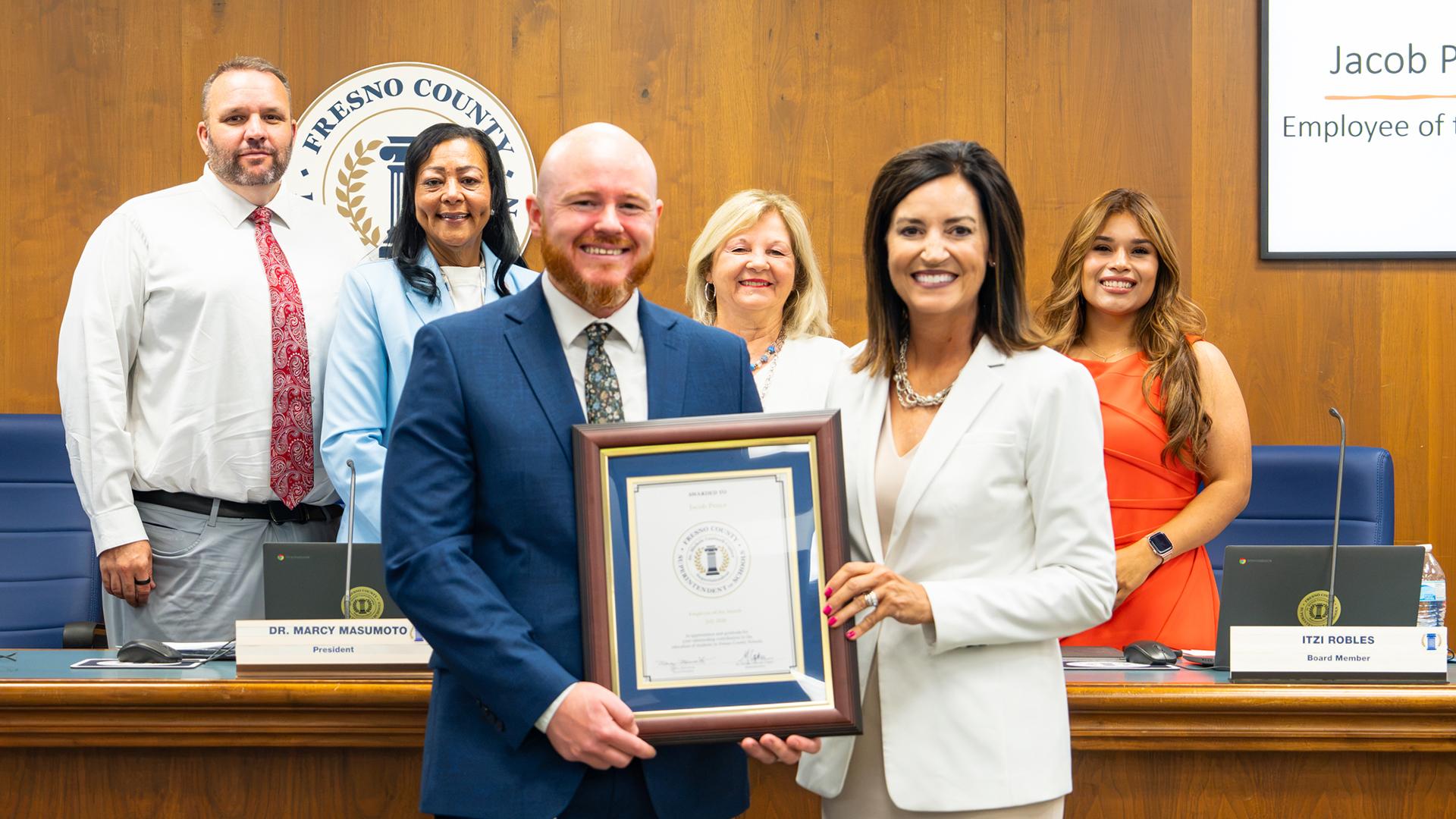 The July Employee of the Month is honored at the monthly board meeting.
