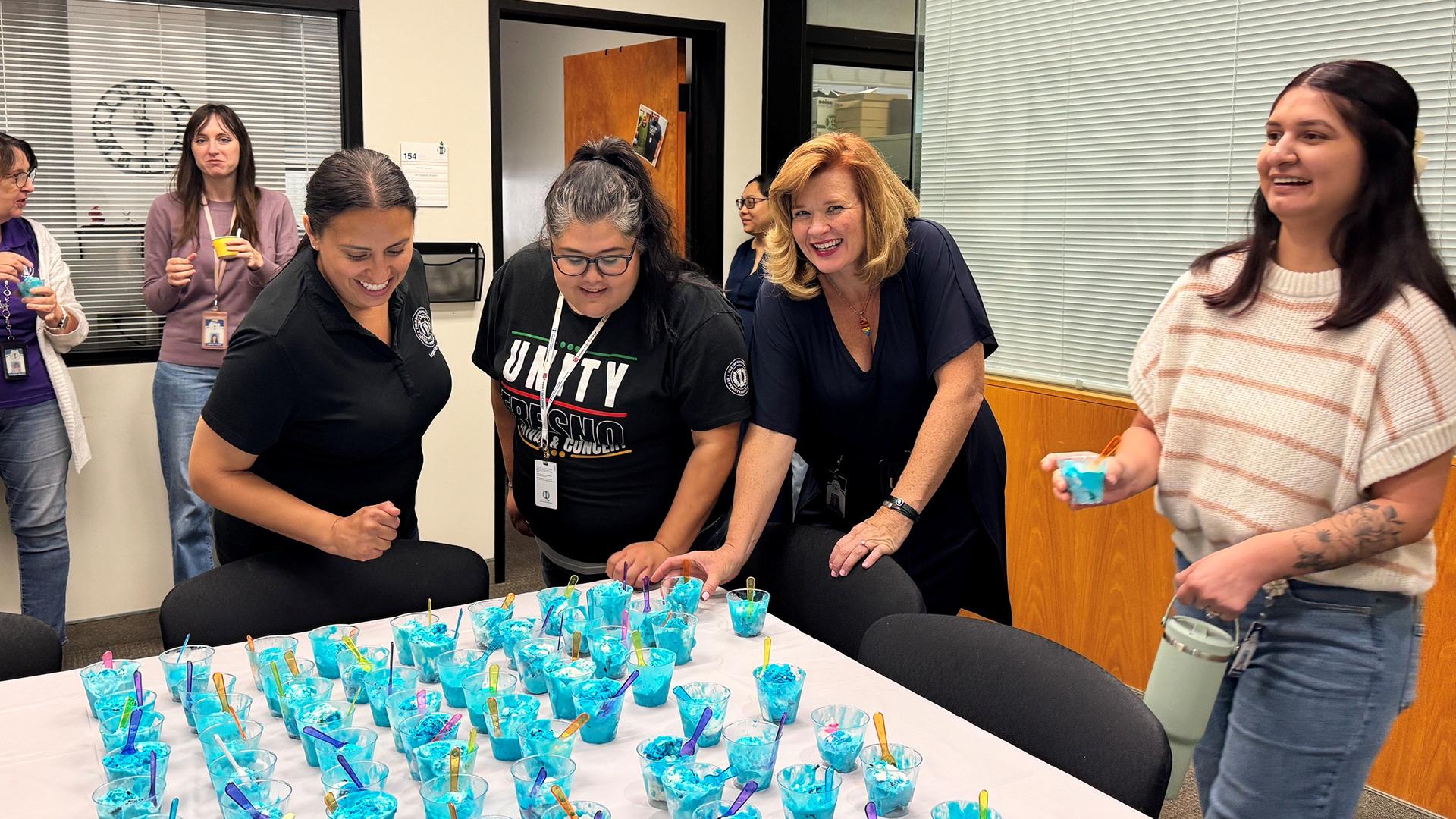 Team members enjoy cups of ice cream. 