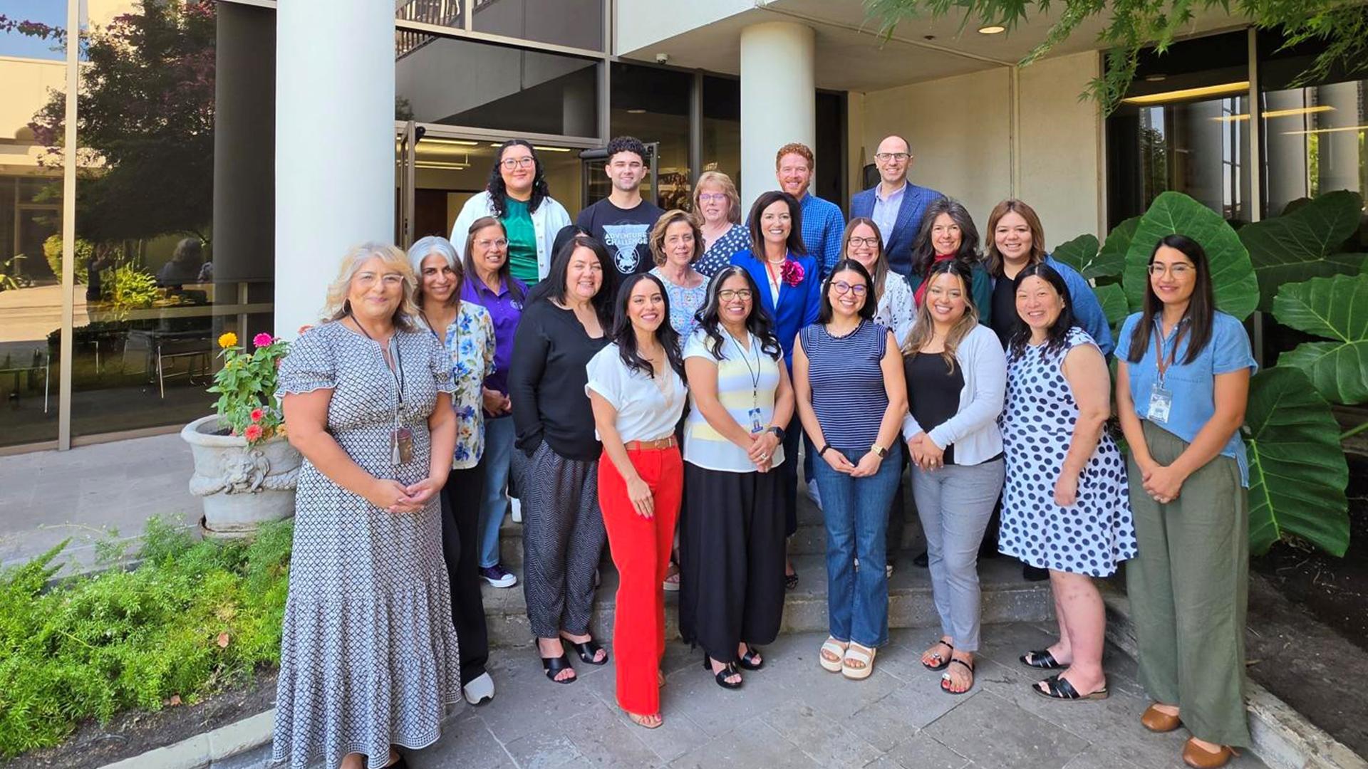 The Internal Finance team poses on the patio for a group picture.