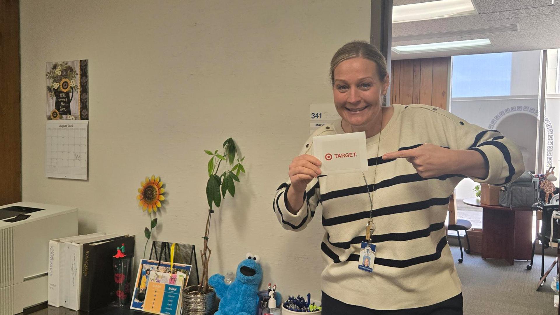 Cathy Troxell shows of her winnings from a random drawing where she won a $50 gift card.
