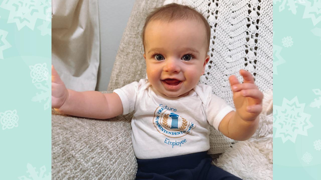 The baby is smiling.