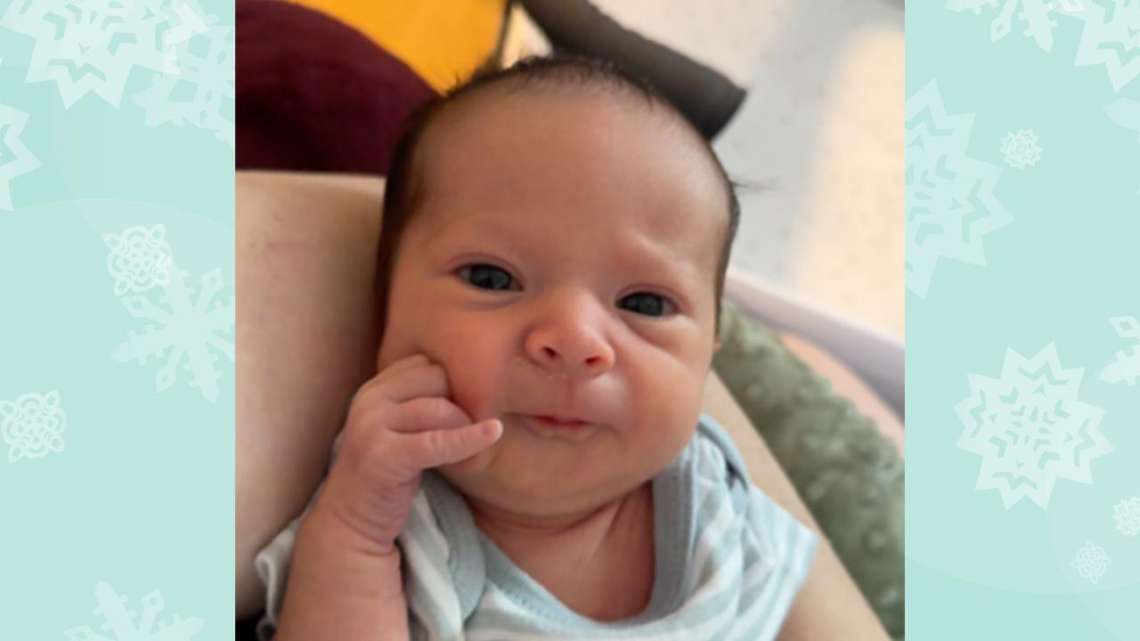 The baby is smiling.