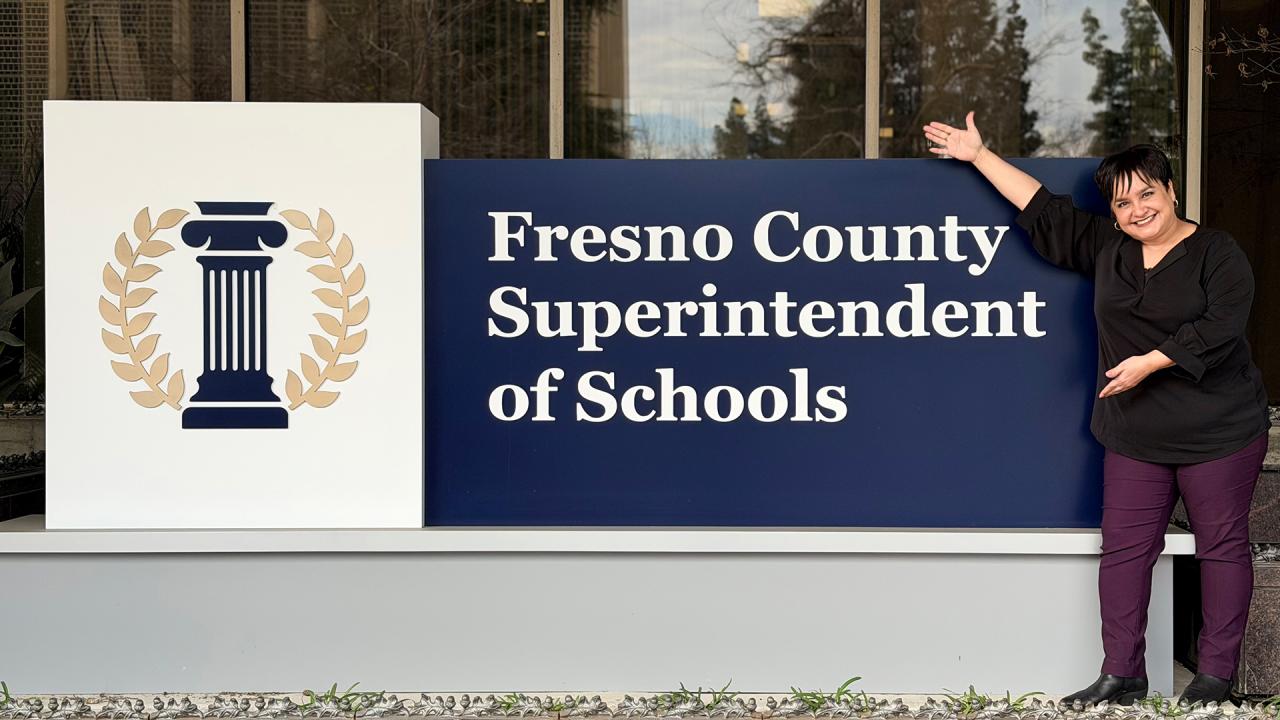 A person is standing in front of a building. 